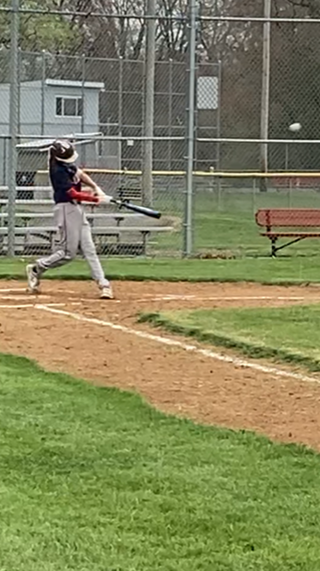 boy hitting on baseball field